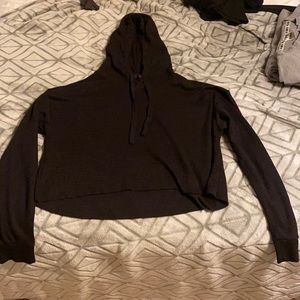 A small black long sleeve sweater.